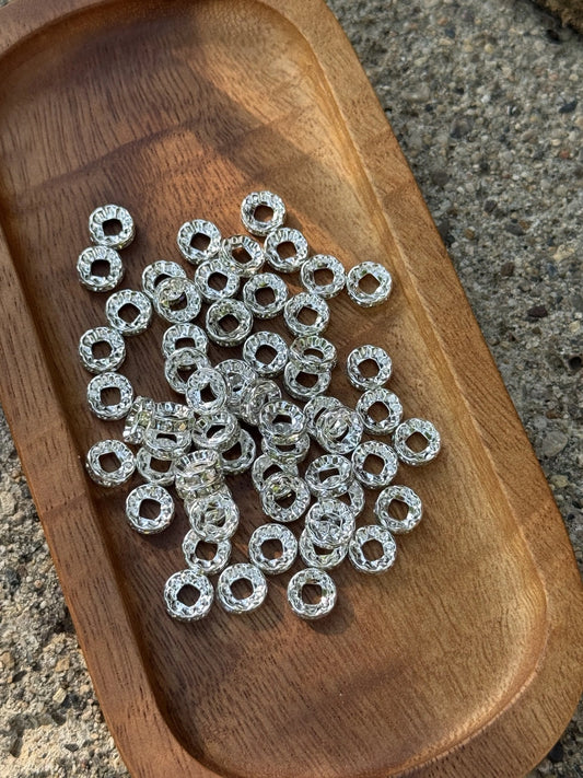 Close-up of premium silver rhinestone spacer beads from Four Seasons of Happiness (FSOH), ideal for separating silicone beads and adding sparkle to beaded pens, keychains, badge reels, wristlets, jewelry, and handmade craft projects.