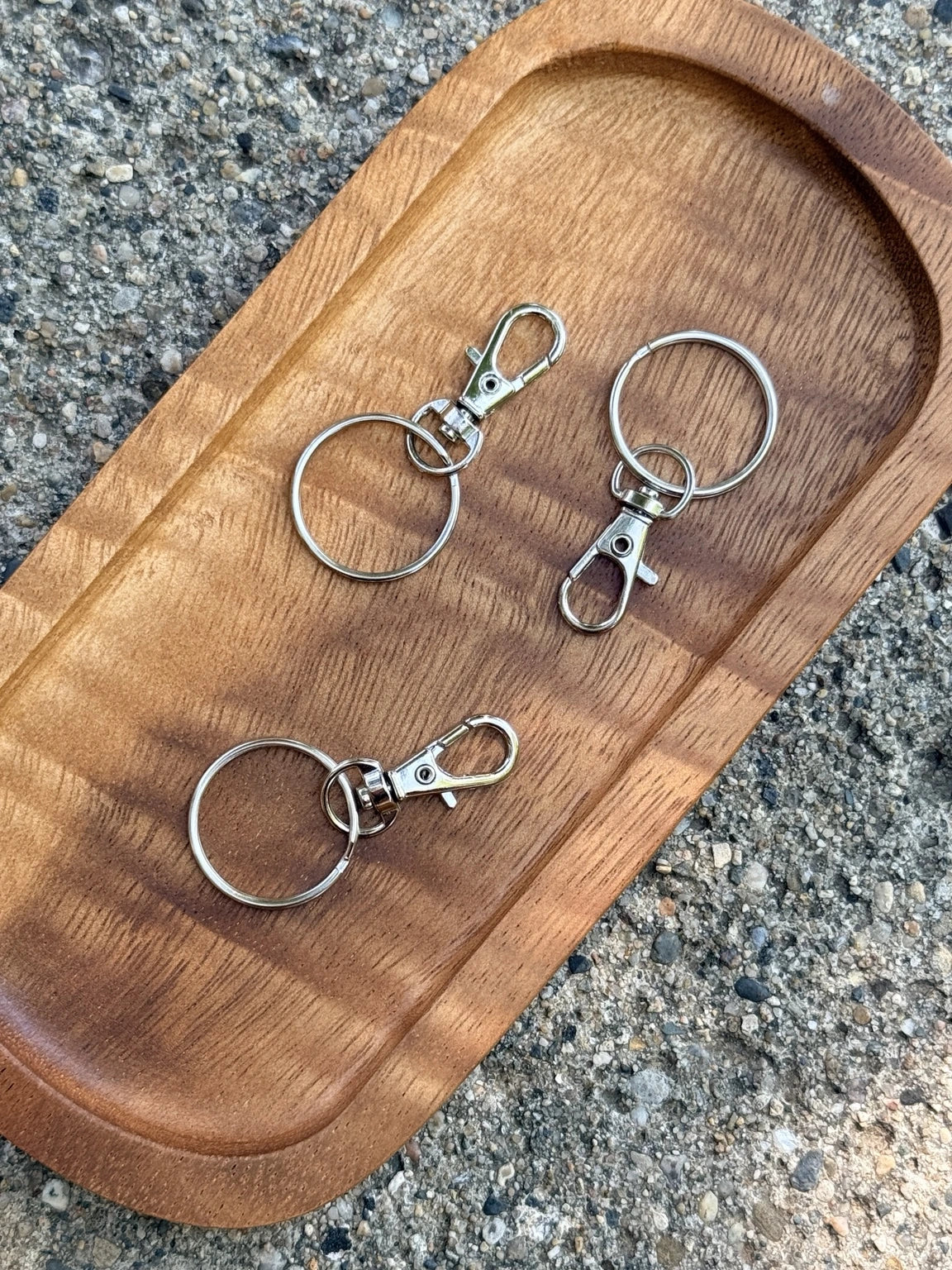 Mini silver 17x38mm lobster clasps with attached key rings, sold in 10-count bags for making keychains, wristlets, bag charms and beaded craft projects.