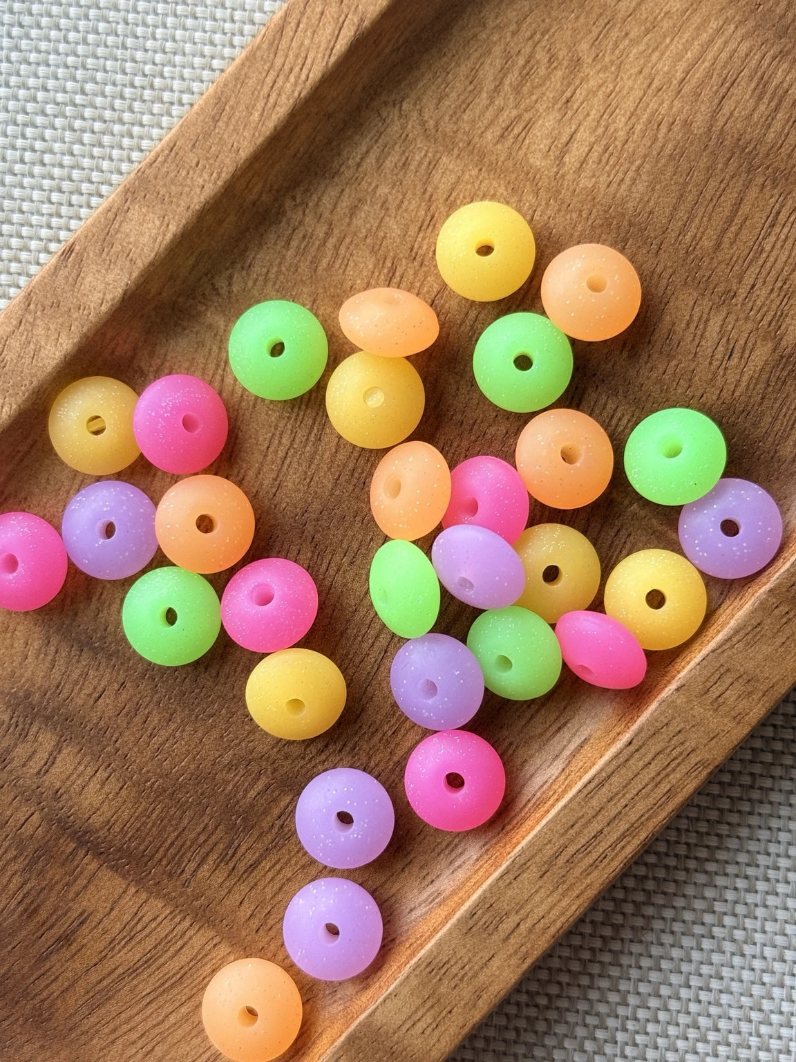 30-count mix of colorful 12mm glow in the dark silicone lentil spacer beads in pink, green, purple, yellow and orange for keychains, wristlets, pens and DIY crafts.