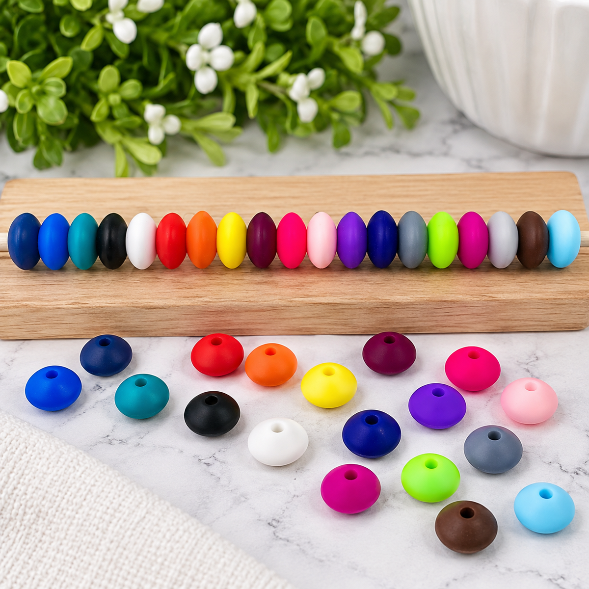 Assorted 12mm silicone lentil spacer beads in a variety of bright colors, available in 50 or 100-count mixed color bags from FSOH.