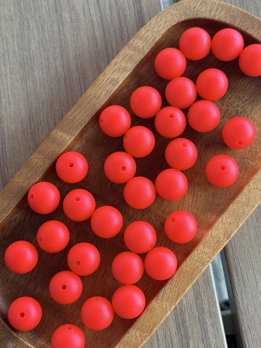     15mm Cherry Pop silicone round beads featuring a vibrant matte red finish for DIY keychains, wristlets, beadable pens, badge reels, and handmade craft projects.
