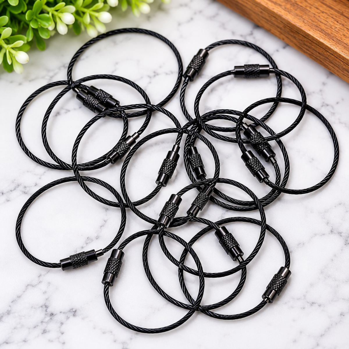 Black 4.3 inch beading wire loops with screw closures for DIY beaded bag charms, keychains and craft projects.
