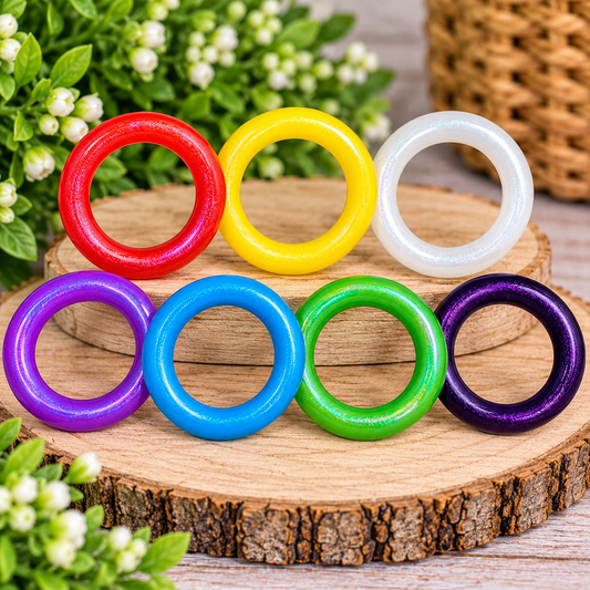 Assorted 65mm silicone opal ring beads in shimmering red, yellow, white, purple, blue, green, and dark purple, perfect for DIY wristlets, keychains, and handmade craft projects.