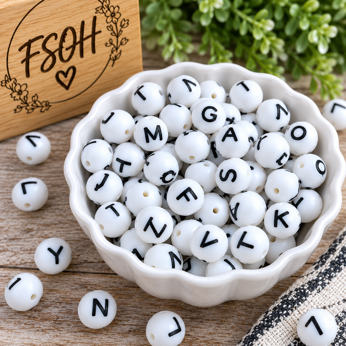 White 15mm round silicone alphabet letter beads with black lettering, sold as a complete 26-count A through Z set for personalized craft projects
