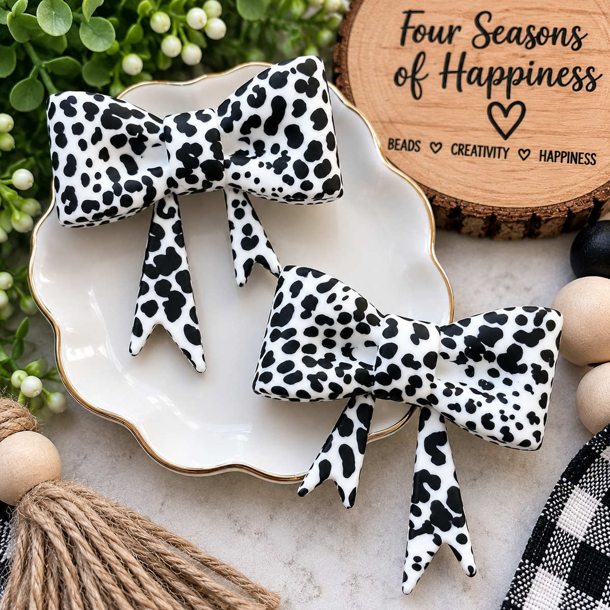 Black Country Cowhide large silicone bow focal featuring a black and white cowhide print with dimensional bow loops and long ribbon tails.