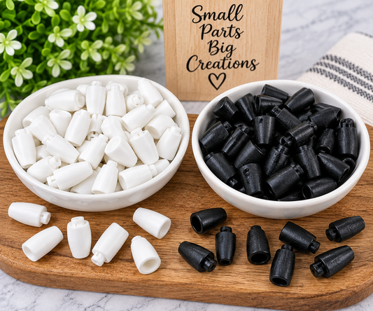 Black and white cord end caps displayed side by side for DIY wristlets, keychains, freshie hangers, bead crafts and other handmade projects from FSOH.