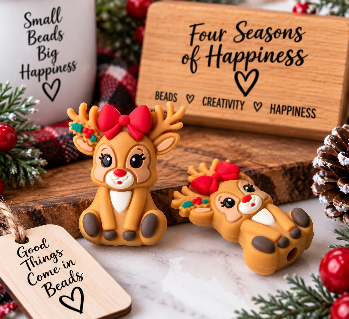 Cute brown Christmas reindeer silicone focal bead with antlers, red bow and festive details, shown from the front and back.