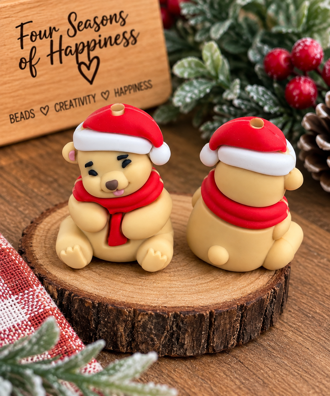 Christmas Santa bear silicone focal bead featuring a tan teddy bear wearing a red Santa hat and scarf, styled with festive greenery and Four Seasons of Happiness branding.