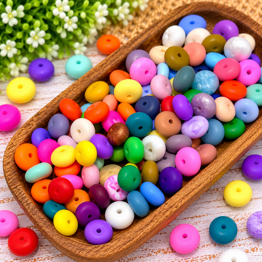 Colorful 14mm silicone abacus spacer beads displayed in a wooden tray, featuring a variety of colors for wristlet keychains and DIY beading.
