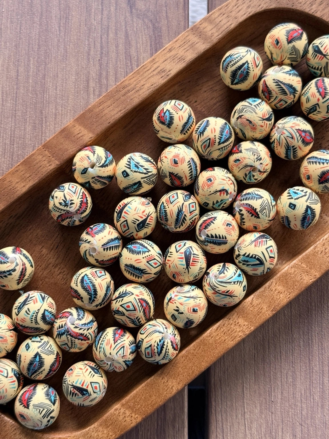 Desert Harmony 15mm printed silicone bead featuring colorful feather and geometric southwestern designs on a cream background.