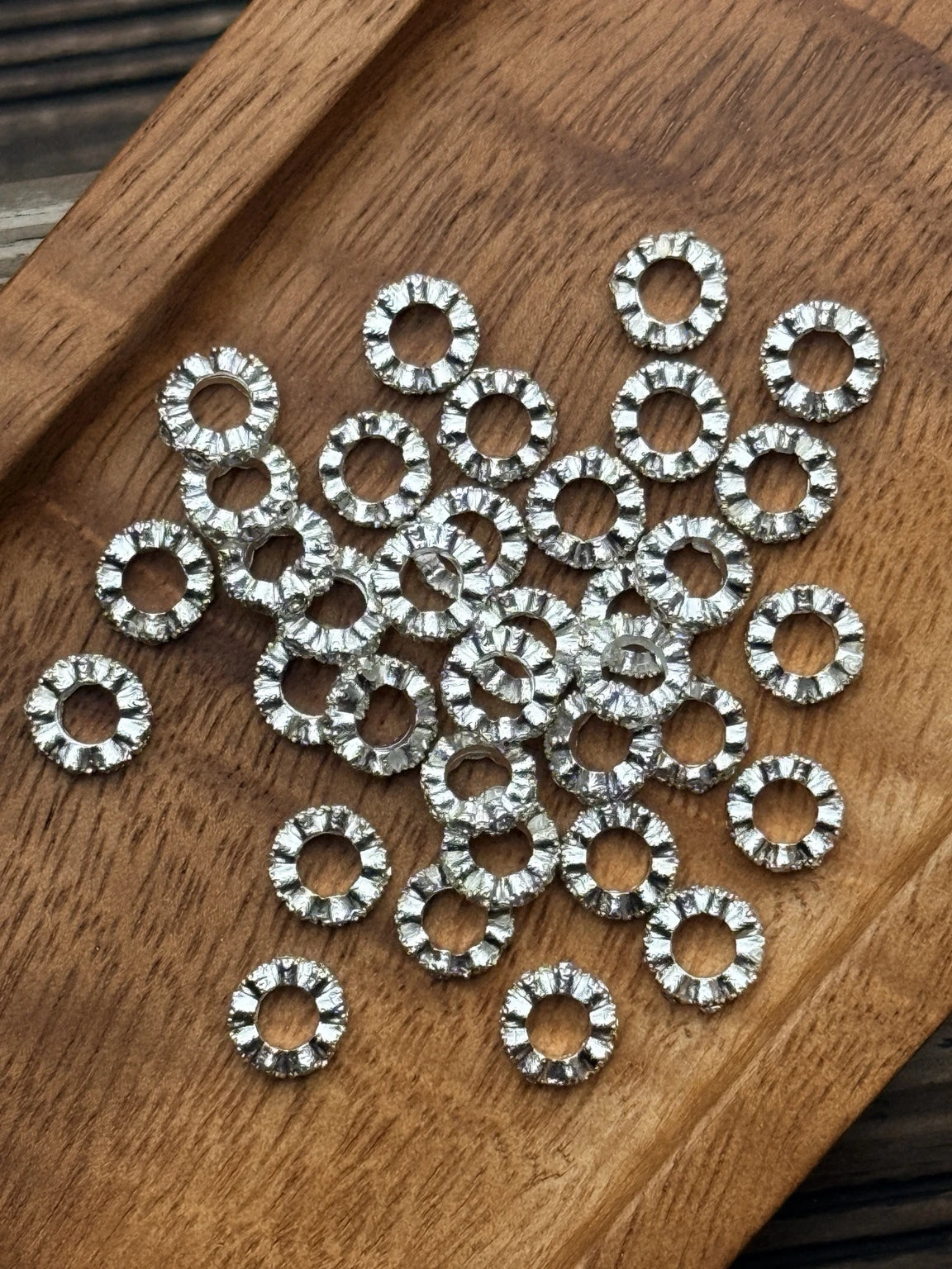 Silver 10mm metal spacer beads featuring sparkling clear rhinestones and textured detailing. Sold in 20-count bags for beadable pens, keychains, wristlets, and DIY crafts.