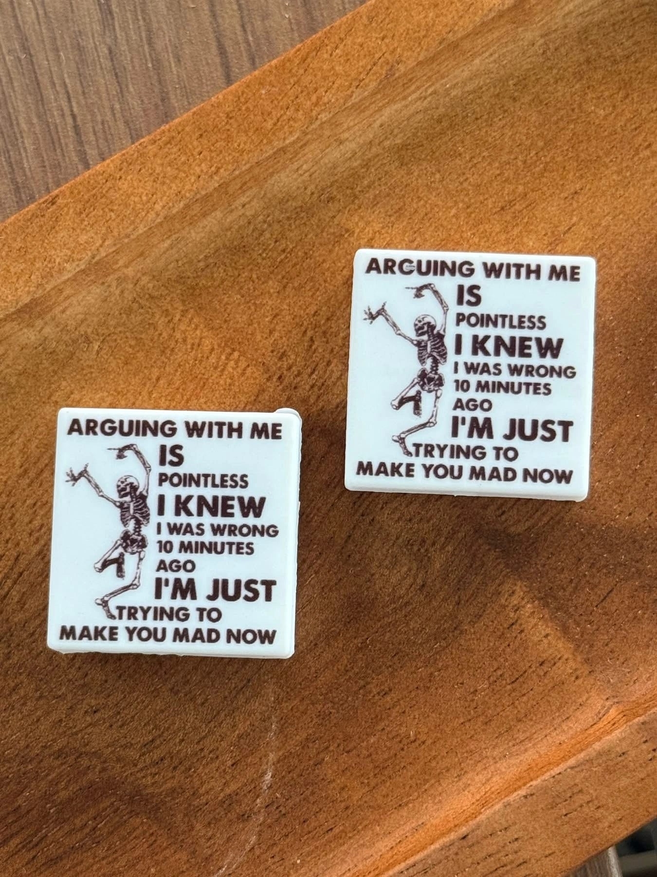 Funny silicone focal bead featuring a dancing skeleton and humorous quote displayed on a wooden tray. Perfect for beadable pens, keychains, wristlets, badge reels, lanyards, and DIY crafting projects.
