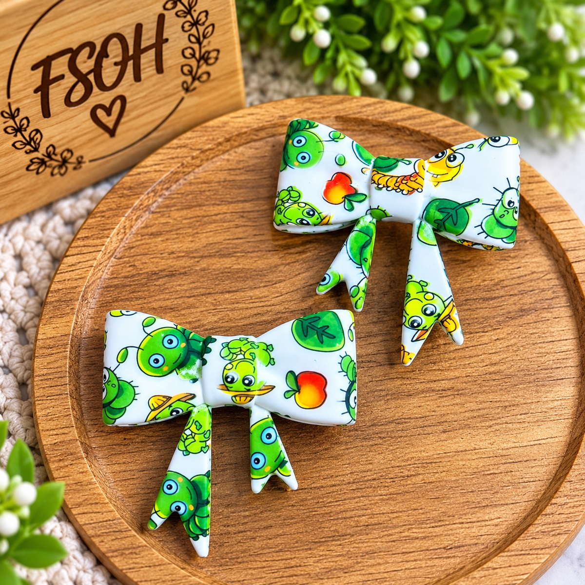 Garden Critters large printed silicone bow focal beads with green garden-themed characters and colorful accents on a white background, sold individually.
