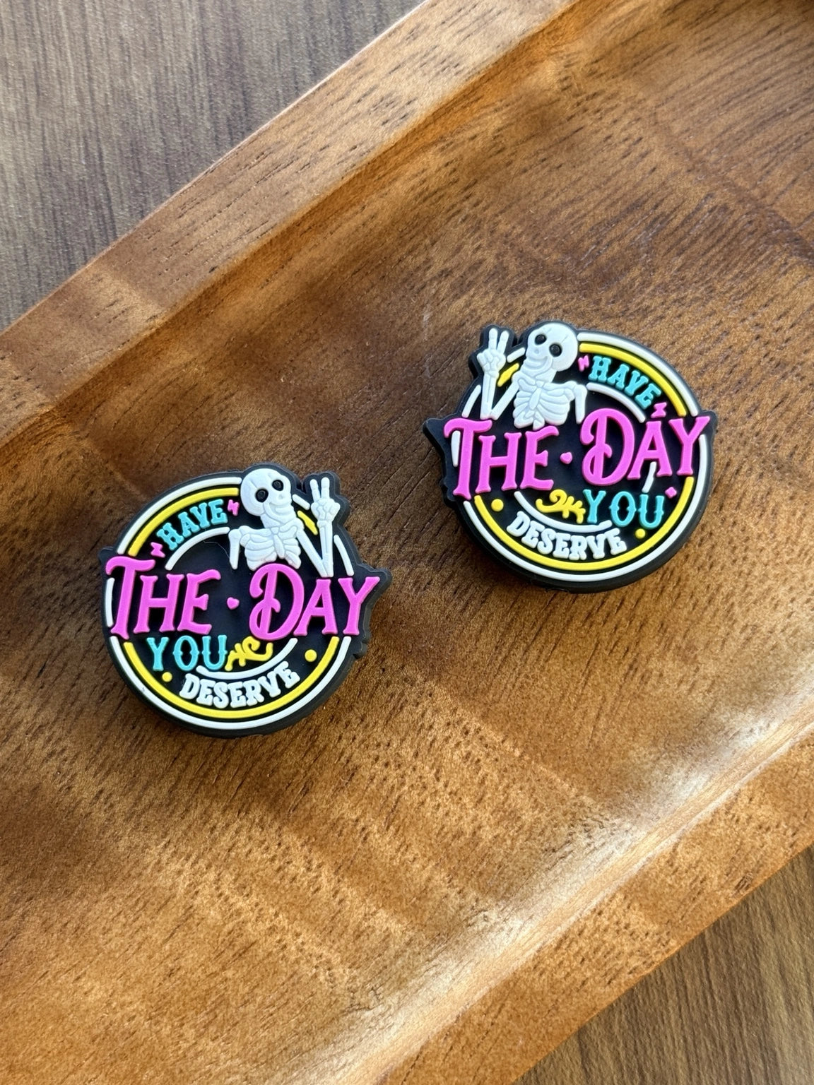     Funny silicone focal bead featuring a peace-sign skeleton and the phrase “Have the Day You Deserve” in colorful neon-inspired lettering for beadable pens, keychains, wristlets, and badge reels.