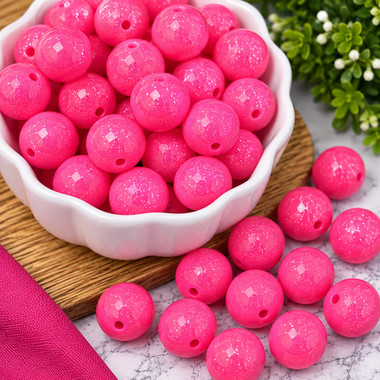 Bright hot pink round beads with a glossy finish and sparkling glitter detail, perfect for wristlets, keychains, jewelry making and colorful craft projects.
