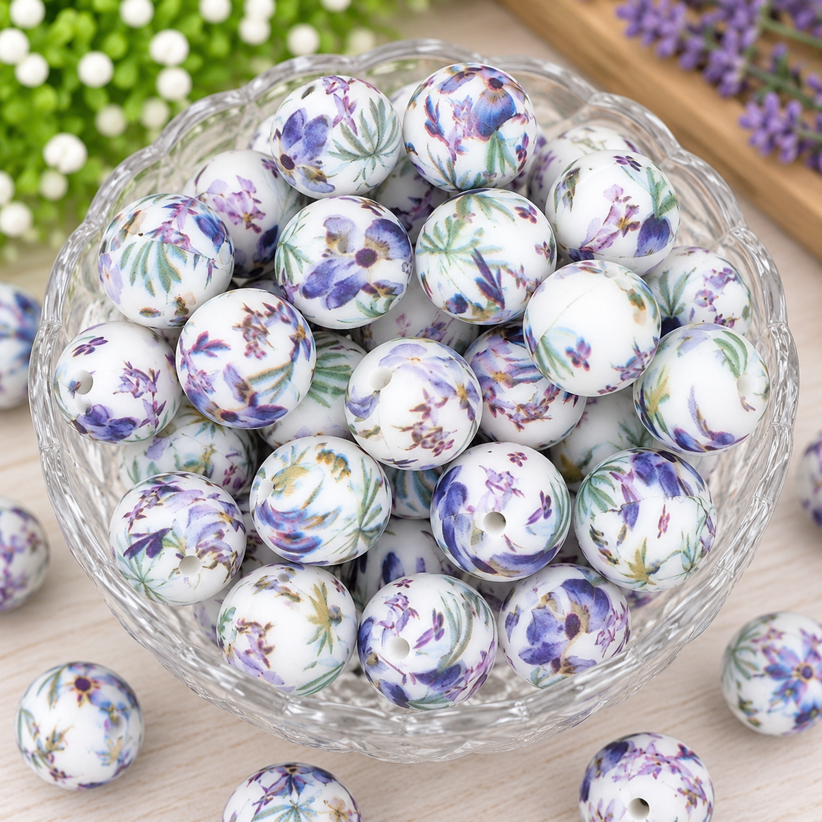 Lavender Meadow 15mm printed silicone beads featuring purple watercolor flowers, green botanical leaves, and a white background displayed in a clear bowl.