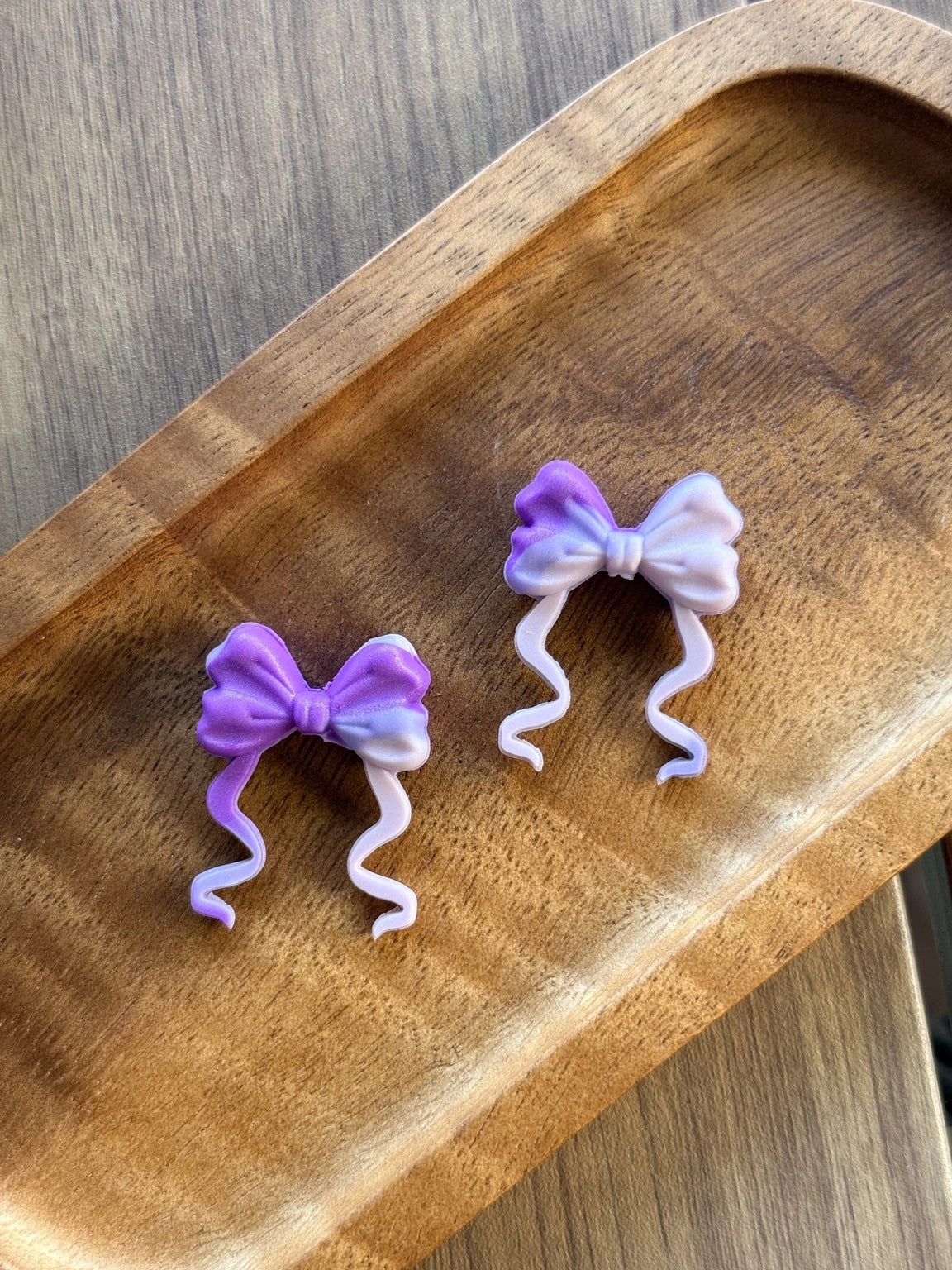     Lavender and lilac ombre silicone focal bead featuring an elegant ribbon bow with flowing tails, perfect for beadable pens, keychains, wristlets, badge reels, and feminine DIY craft projects.