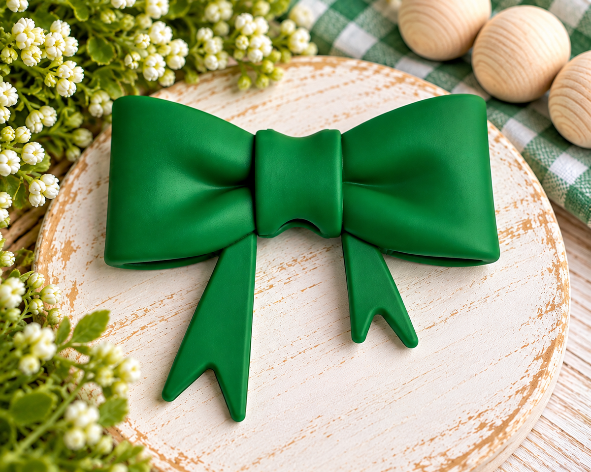 Lucky Clover solid green large silicone bow focal bead with asymmetrical tails for wristlets, bag charms, keychains and DIY beading projects.