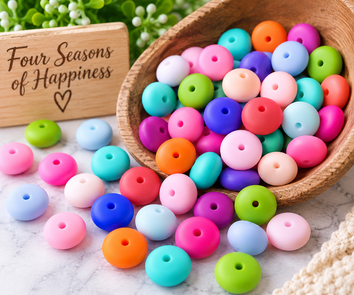 Mixed color silicone lentil spacer beads in bright and pastel shades displayed with Four Seasons of Happiness branded ribbon.