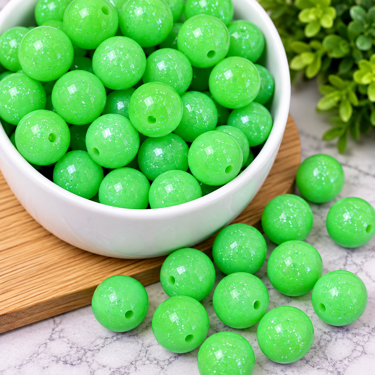 Bright neon green round beads with a glossy finish and sparkling glitter detail, shown in a white dish with loose beads displayed for jewelry, keychain and craft projects.