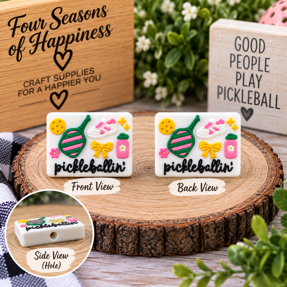 White Pickleballin’ silicone focal bead featuring a colorful pickleball paddle, ball, sneaker, bow and coordinating pink, green and yellow details.