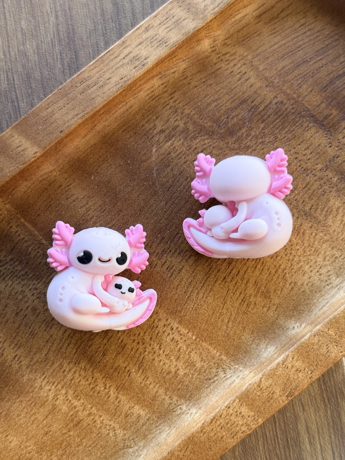     Pink axolotl silicone focal bead featuring a cute mama axolotl cuddling a baby axolotl, perfect for beadable pens, keychains, wristlets, badge reels, and kawaii DIY craft projects.