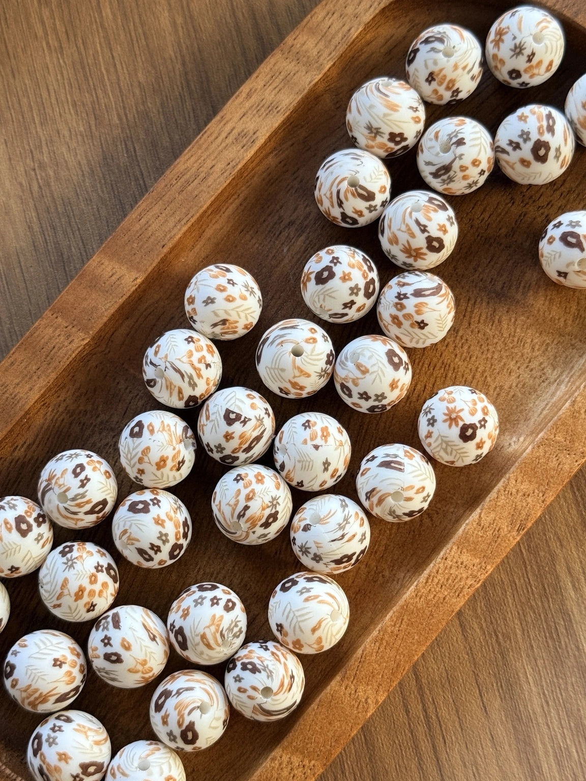     15mm printed silicone beads featuring delicate floral and botanical designs in caramel, mocha, honey, and cream tones on a white background, perfect for beadable pens, wristlets, keychains, badge reels, and DIY craft projects