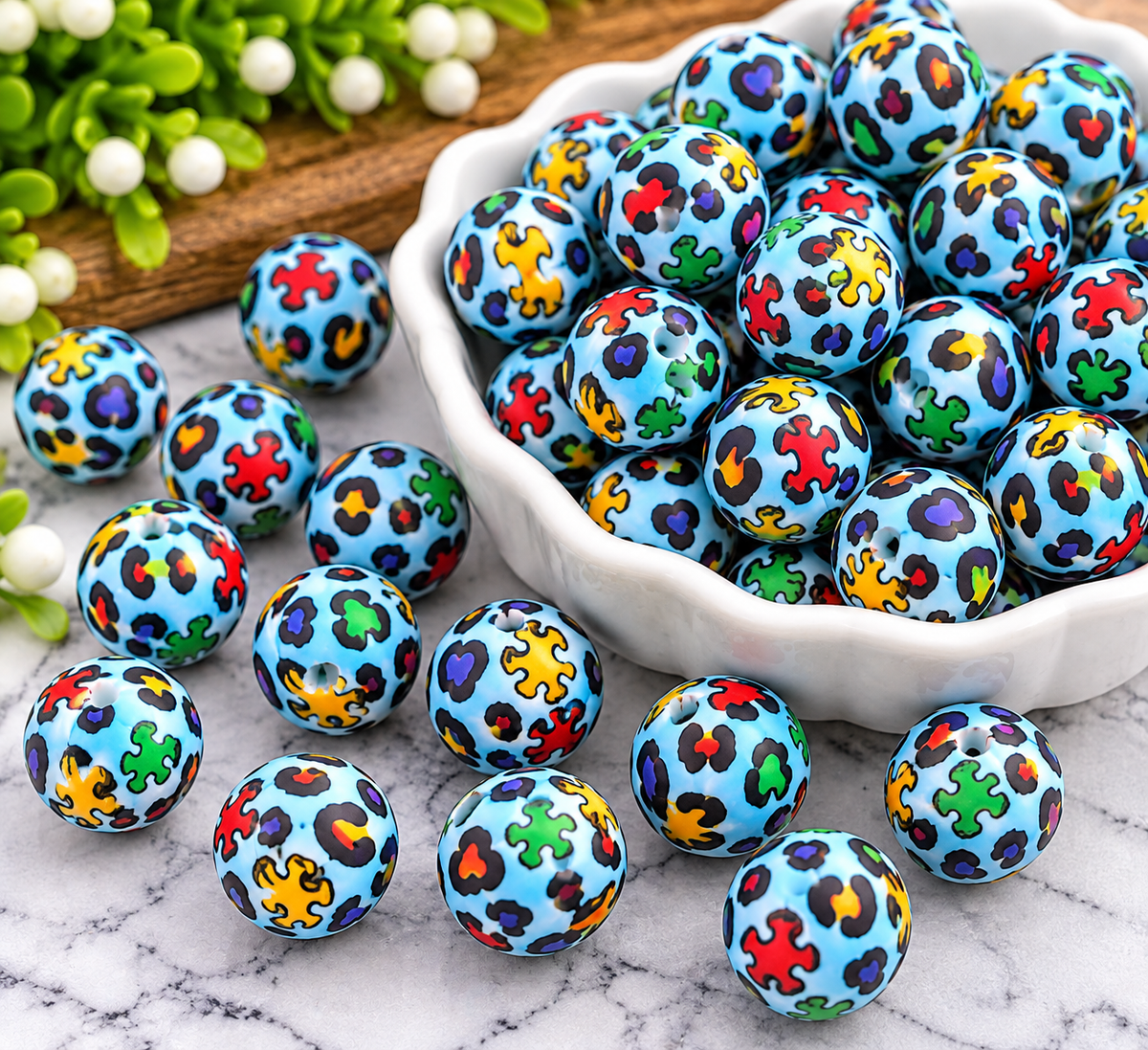 Autism in Color 15mm printed silicone bead featuring colorful puzzle-inspired shapes and hearts on a light blue background, sold individually by FSOH.