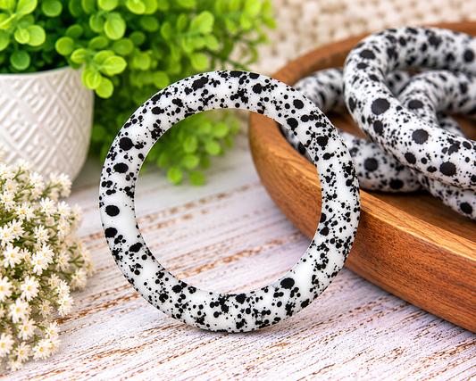Midnight Splatter 65mm silicone ring bead with a white base and irregular black splatter print for wristlet keychains and DIY crafts.