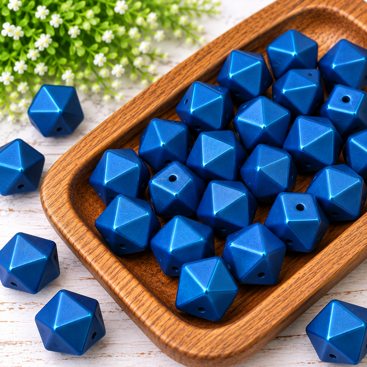 Blue Horizon 14mm metallic silicone hexagon beads with subtle green undertones displayed in a wooden tray