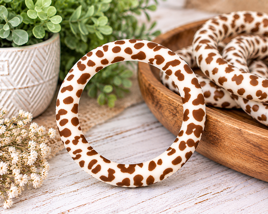 Brown Country Cowhide 65mm silicone ring bead featuring a warm brown and creamy white cowhide print for wristlet keychains and DIY crafts.