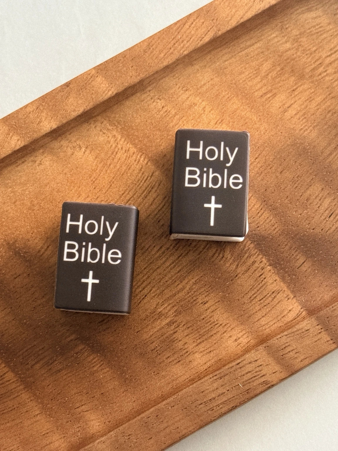 Faithful Words black Holy Bible silicone focal bead featuring white Holy Bible lettering, a white cross and page details for faith-inspired beaded crafts.