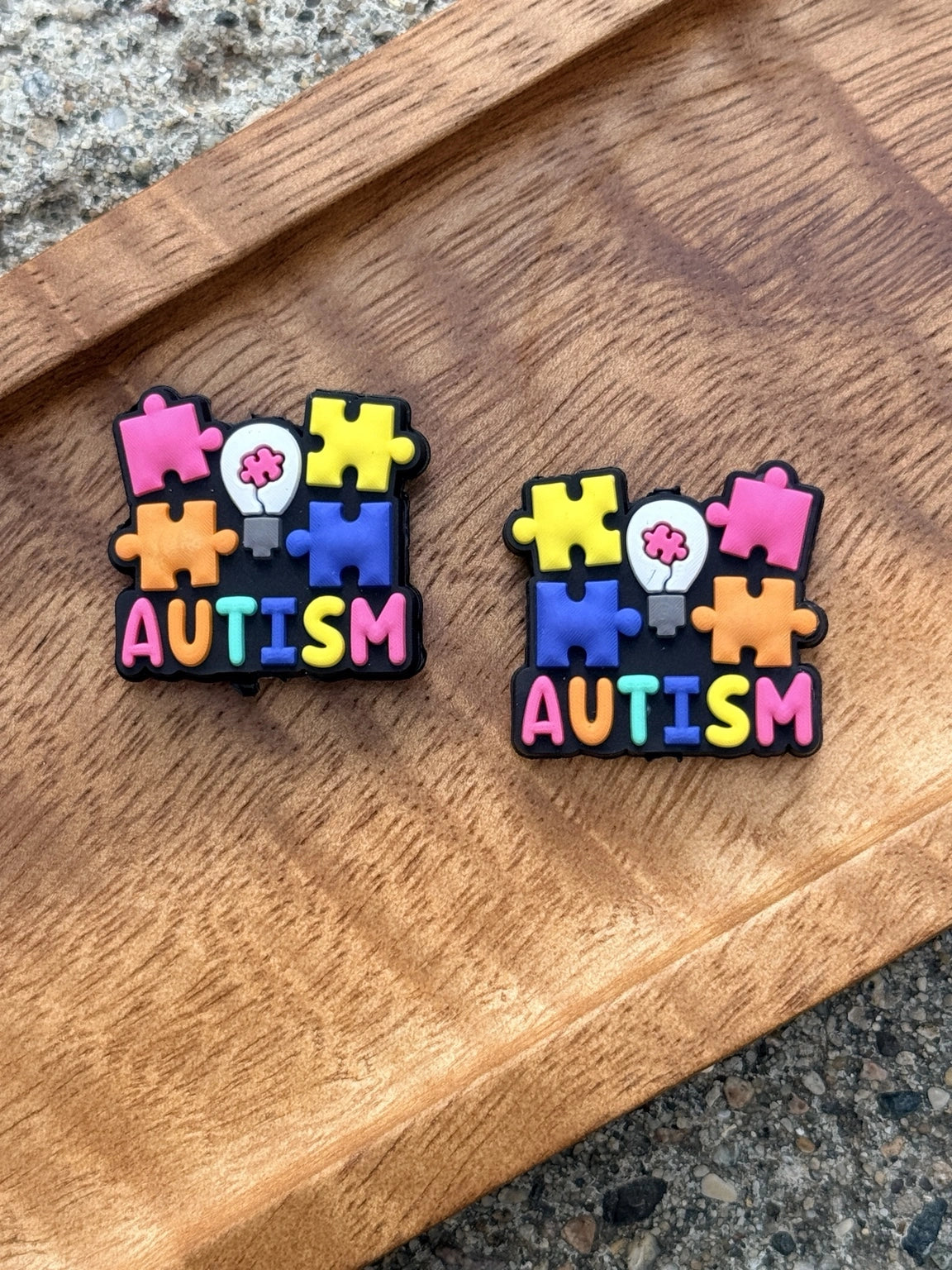 Autism awareness silicone focal bead featuring colorful puzzle pieces and awareness design for DIY keychains, wristlets, badge reels, beadable pens, and handmade gifts.