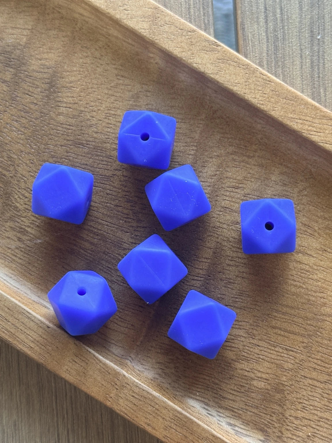 Blueberry Bliss 14mm silicone hexagon beads displayed in a wooden tray for beadable pens, keychains, wristlets, badge reels, and DIY craft projects.