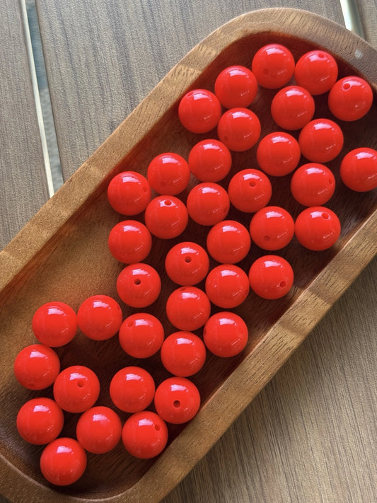 Glossy Cherry Pop Liquid 15mm silicone beads from Four Seasons of Happiness displayed in a wooden tray. Premium food-grade silicone beads sold individually for beaded pens, wristlets, keychains, badge reels, jewelry making, and DIY craft projects