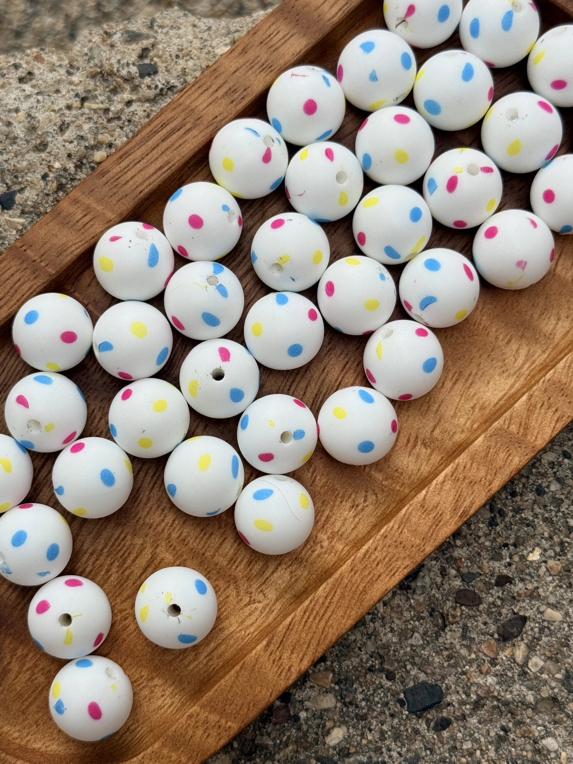 15mm silicone printed bead featuring colorful pink, blue, and yellow confetti dots on a white background for DIY keychains, wristlets, beadable pens, and handmade crafts.
