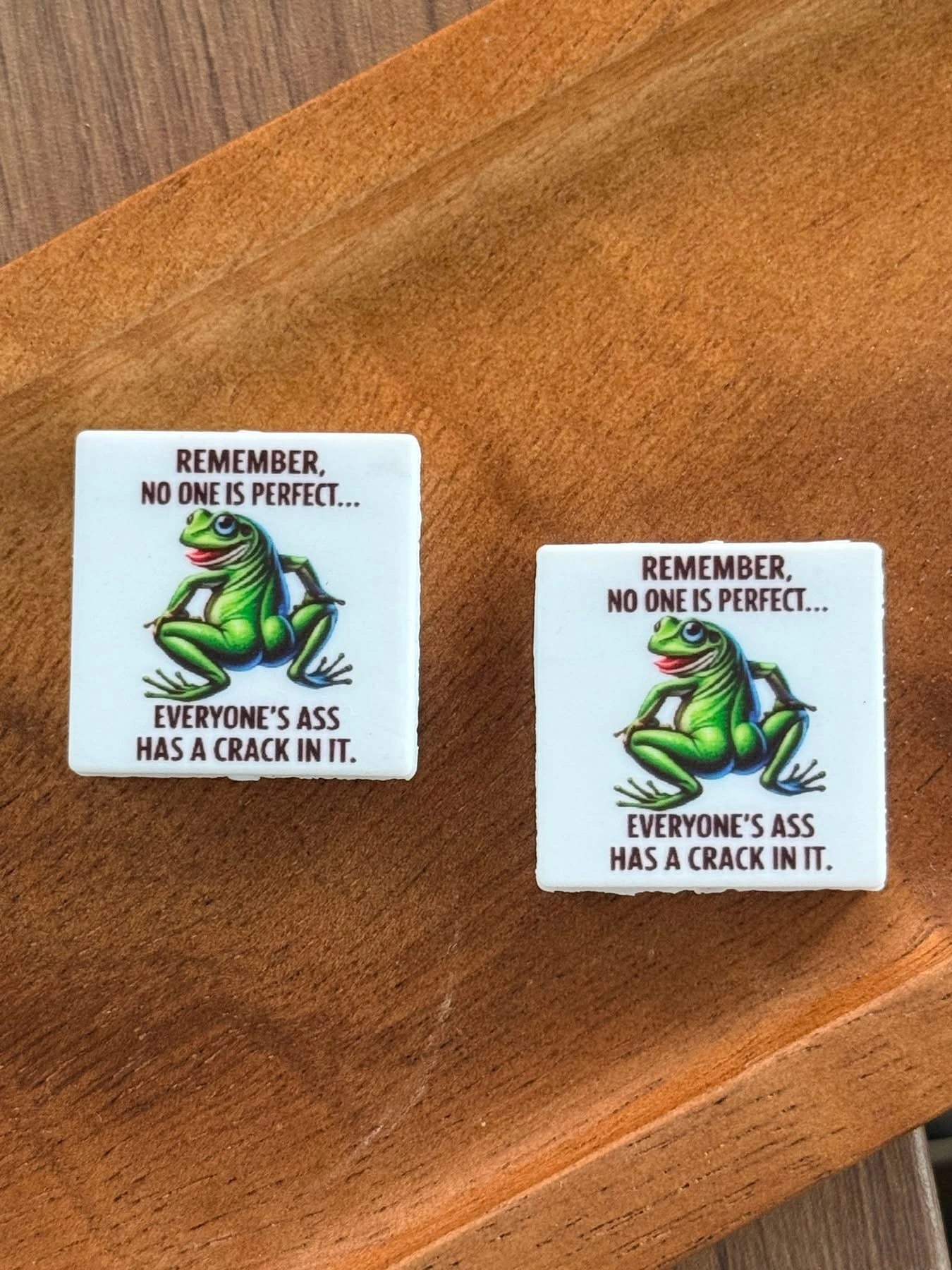 Funny frog silicone focal bead featuring the phrase “Remember, No One Is Perfect… Everyone’s Ass Has a Crack in It” for beadable pens, keychains, wristlets, badge reels, and DIY craft projects.