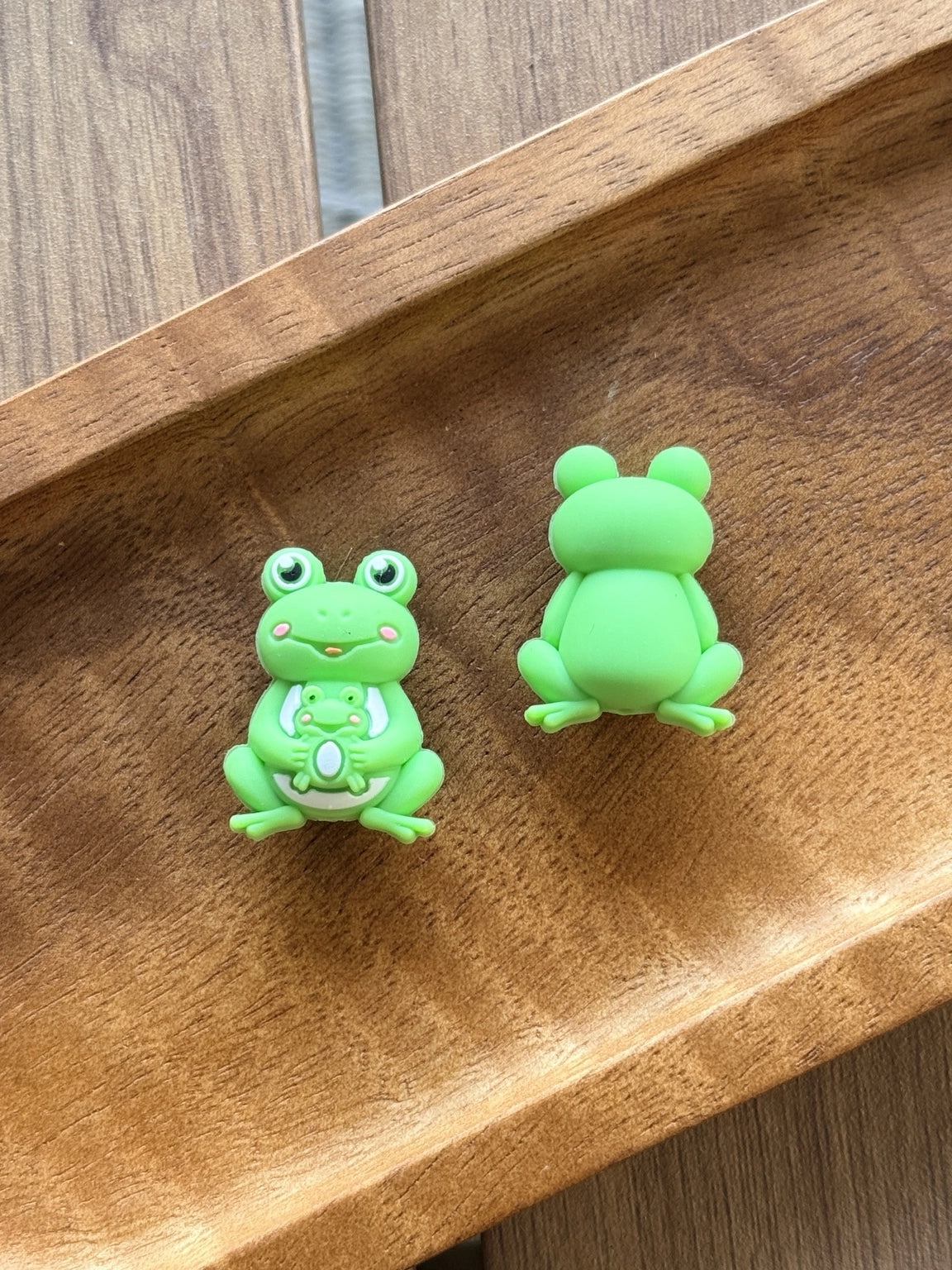 Green frog silicone focal bead holding a baby frog companion, perfect for beadable pens, keychains, wristlets, badge reels, bookmarks, and DIY craft projects.