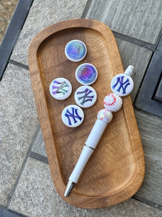 iridescent baseball themed acrylic focal beads displayed with beadable pen on wooden tray