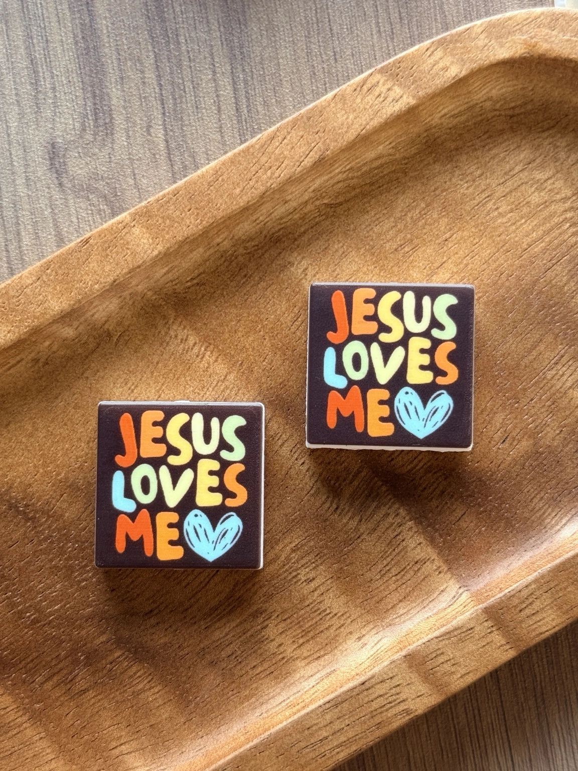 Jesus Loves Me silicone focal bead from Four Seasons of Happiness featuring colorful lettering and a blue heart. Premium Christian silicone focal bead sold individually for beaded pens, keychains, wristlets, badge reels, and faith-inspired DIY craft projects.