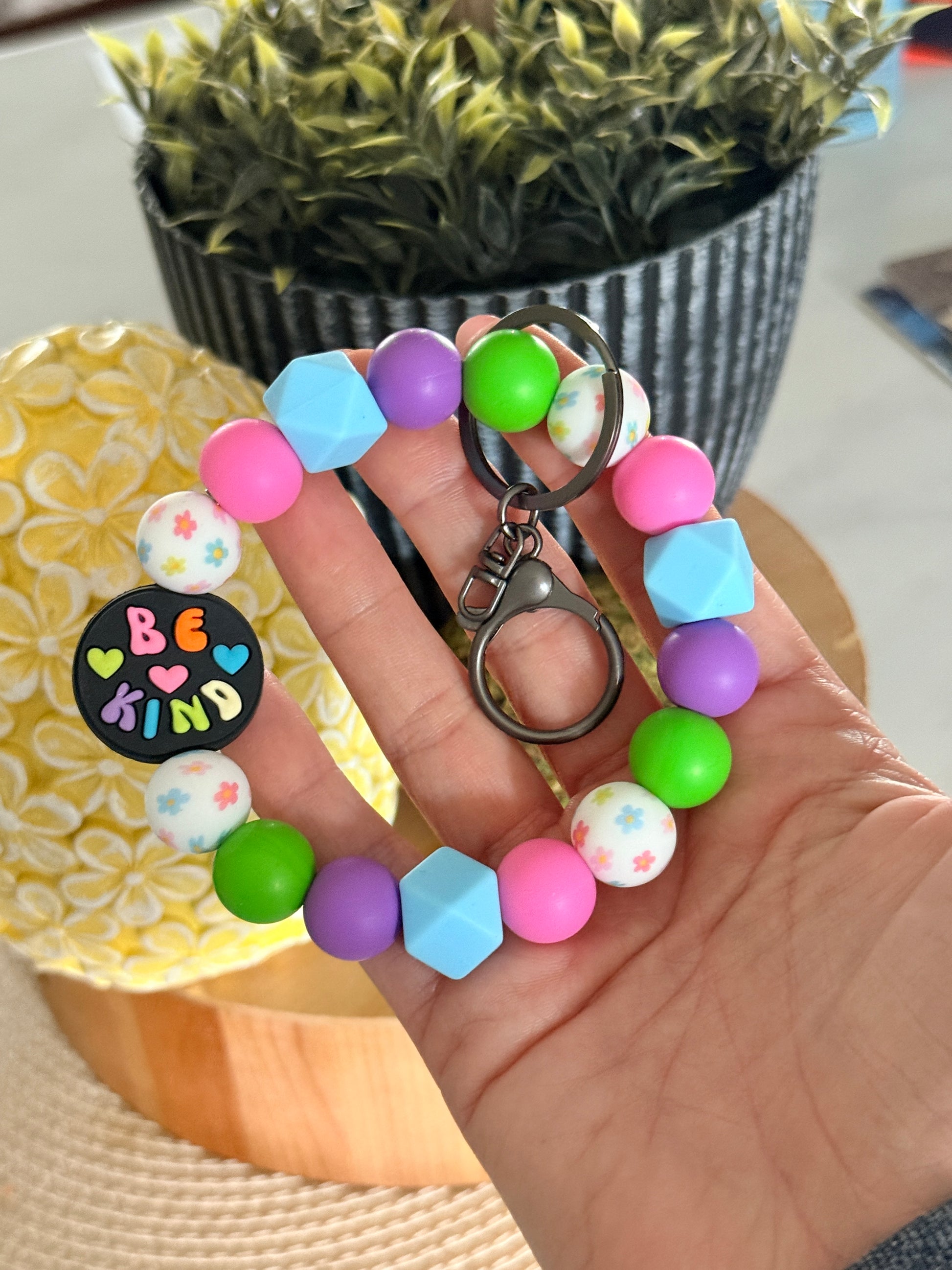 FSOH silicone wristlet keychain with pastel beads, floral accents, and Be Kind charm in colorful design