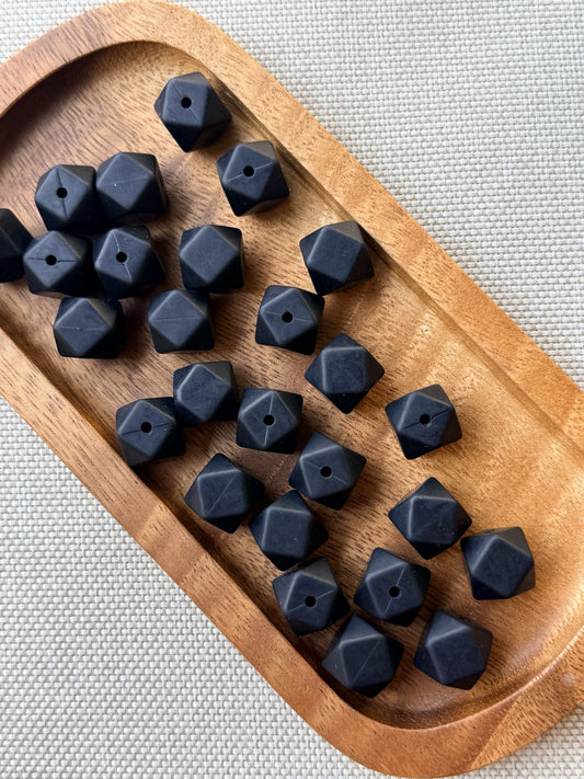Midnight Onyx matte black 14mm silicone hexagon beads with a faceted geometric design. Premium silicone craft beads available in 5 or 10 count bags for beaded pens, keychains, wristlets, badge reels, and DIY projects.
