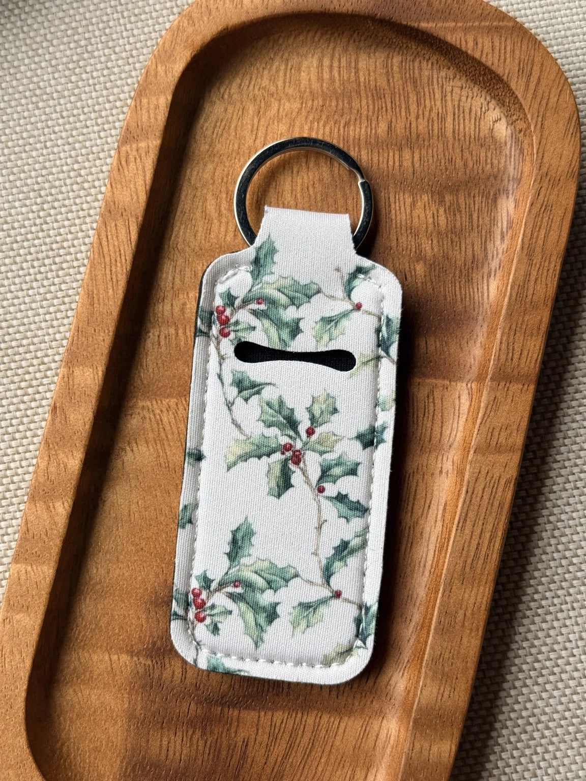 Soft neoprene chapstick holder keychain by Four Seasons of Happiness featuring assorted floral, Christmas, winter, holiday and seasonal printed designs with a durable metal keyring.