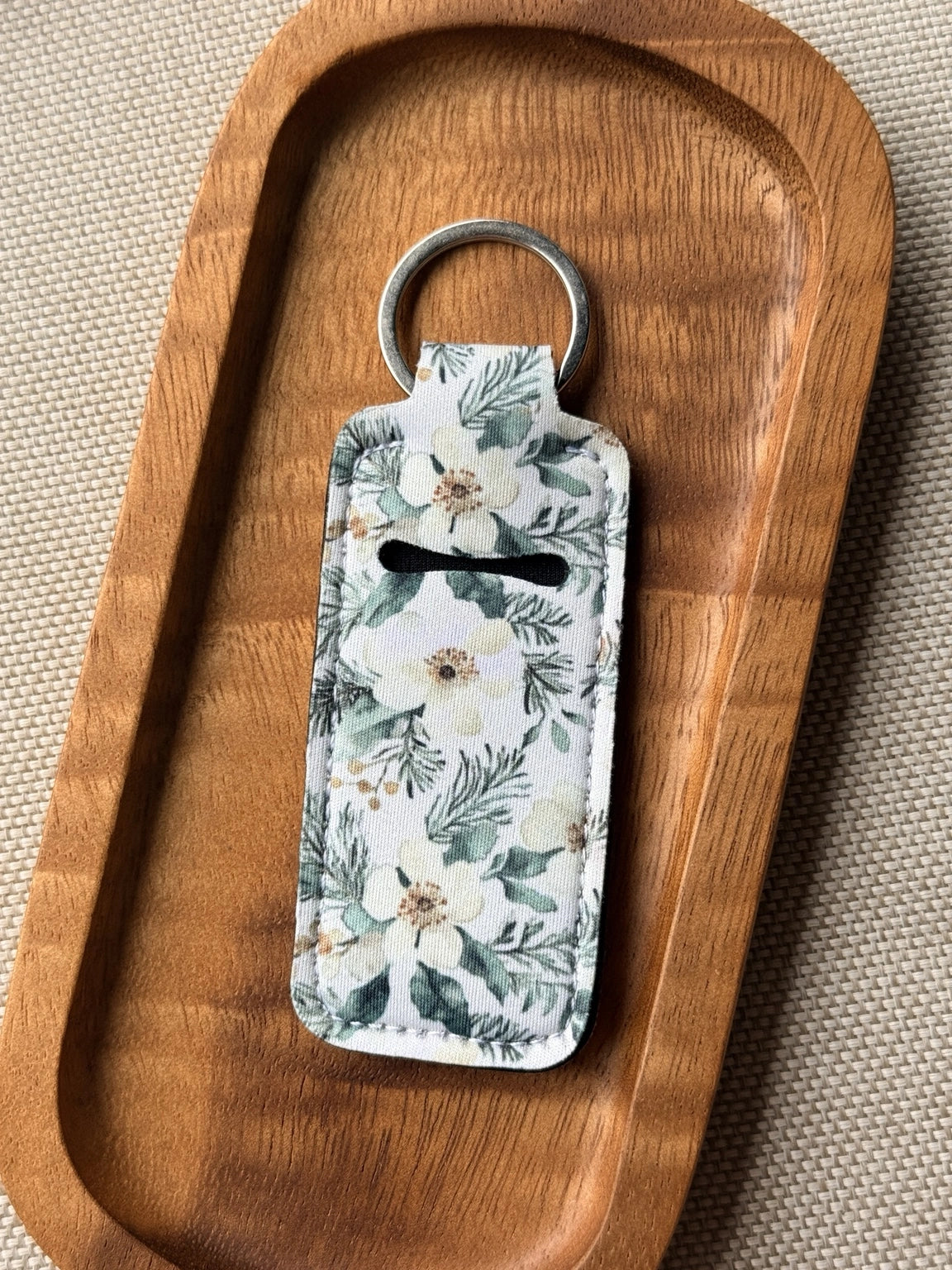Soft neoprene chapstick holder keychain by Four Seasons of Happiness featuring assorted floral, Christmas, winter, holiday and seasonal printed designs with a durable metal keyring.