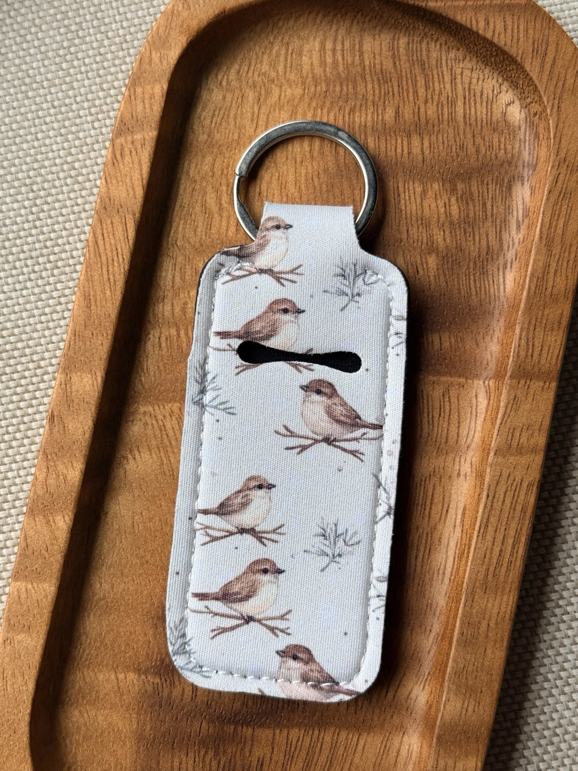 Soft neoprene chapstick holder keychain by Four Seasons of Happiness featuring assorted floral, Christmas, winter, holiday and seasonal printed designs with a durable metal keyring.