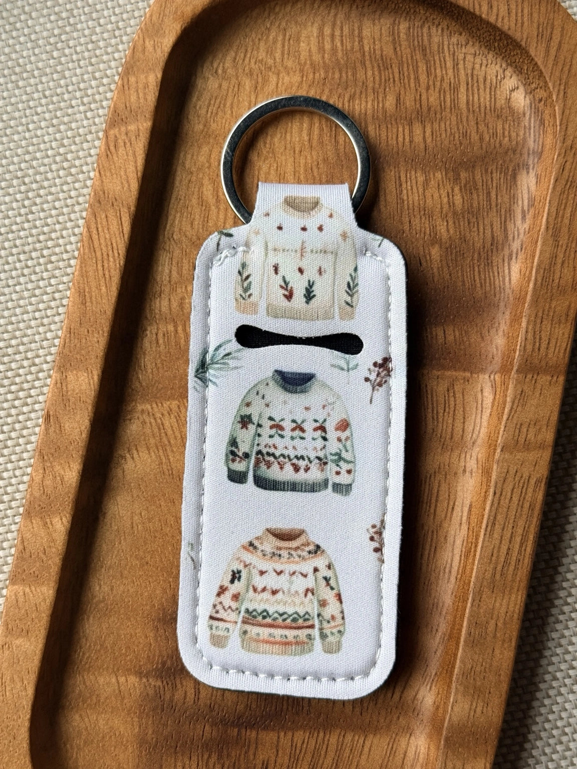 Soft neoprene chapstick holder keychain by Four Seasons of Happiness featuring assorted floral, Christmas, winter, holiday and seasonal printed designs with a durable metal keyring.