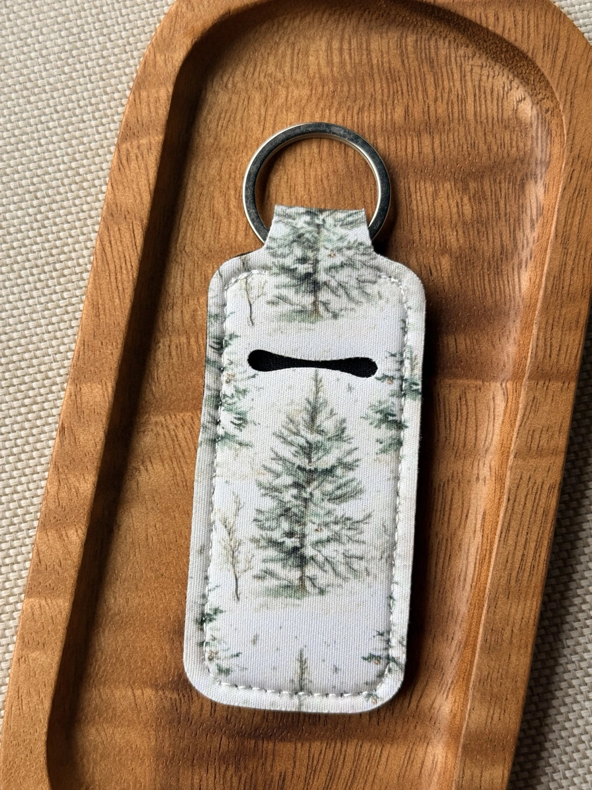 Soft neoprene chapstick holder keychain by Four Seasons of Happiness featuring assorted floral, Christmas, winter, holiday and seasonal printed designs with a durable metal keyring.