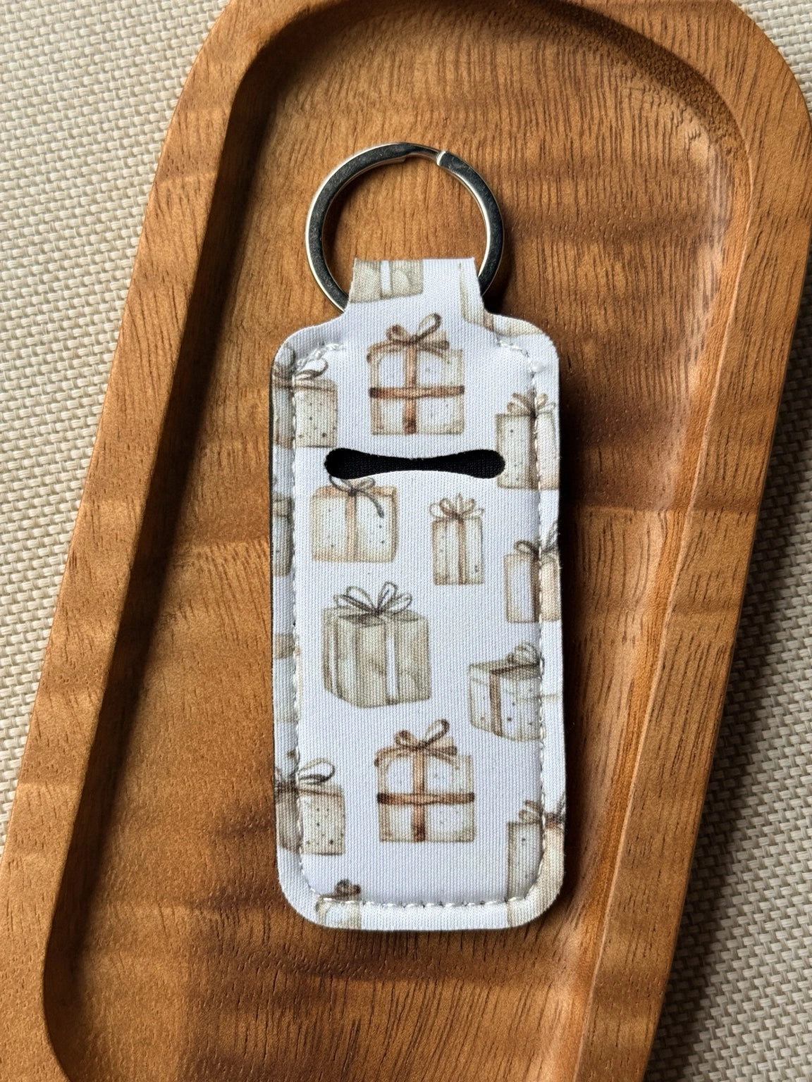 Soft neoprene chapstick holder keychain by Four Seasons of Happiness featuring assorted floral, Christmas, winter, holiday and seasonal printed designs with a durable metal keyring.