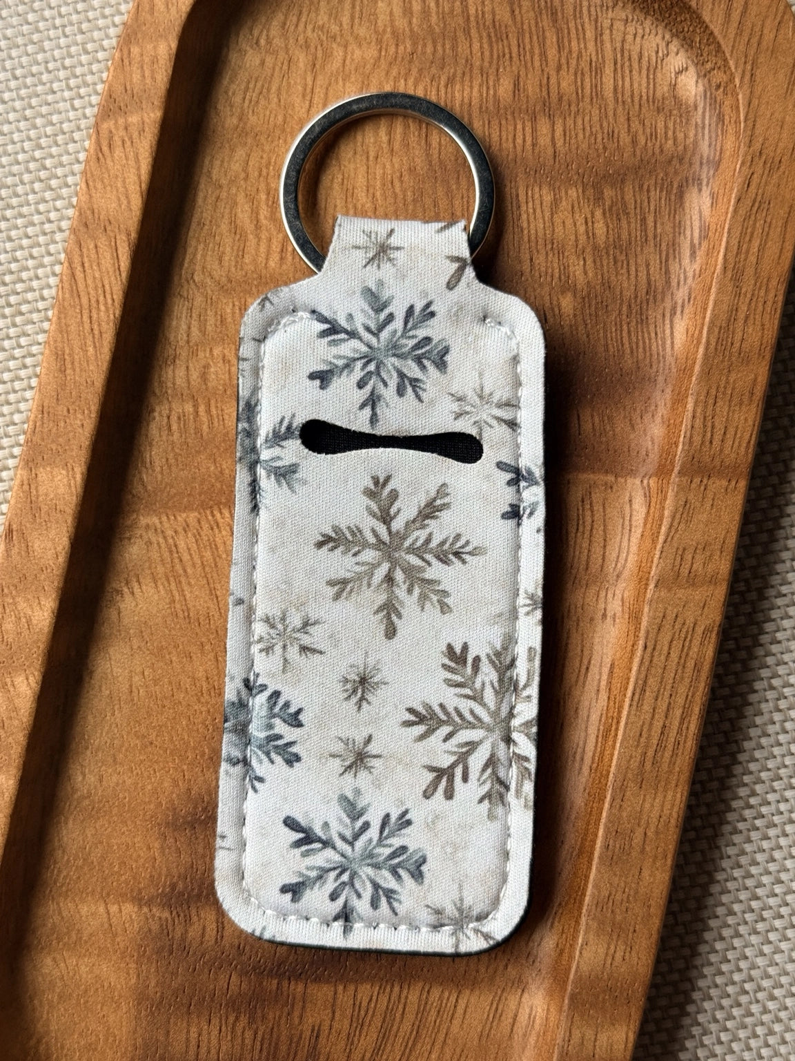 Soft neoprene chapstick holder keychain by Four Seasons of Happiness featuring assorted floral, Christmas, winter, holiday and seasonal printed designs with a durable metal keyring.