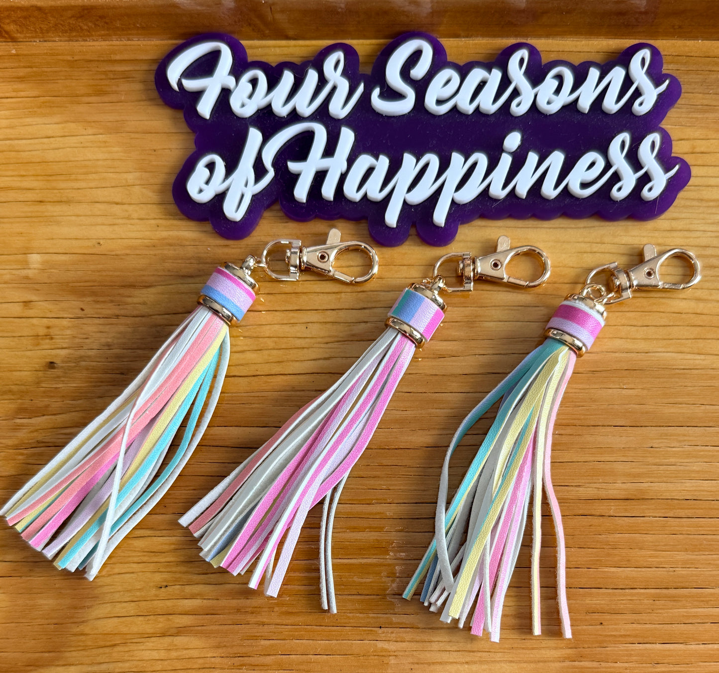 Pastel rainbow faux leather tassel keychain charm from Four Seasons of Happiness with gold hardware for keychains, purse charms, and DIY accessories